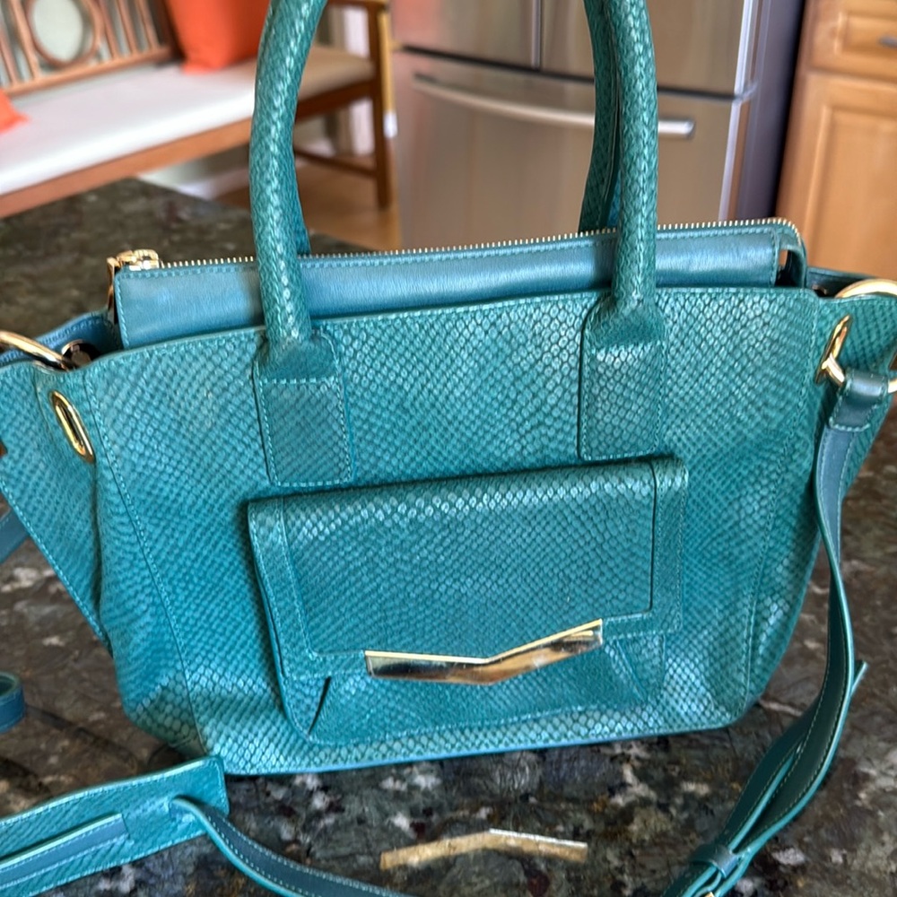 Time’s Arrow emerald green snakeskin embossed leather crossbody bag